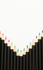 Black pencils with colored tips, white background
