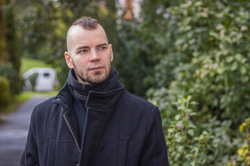 A man walks in the dripping rain in a small city in Hungary