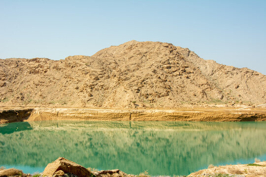 Turquoise lake at the foot of Jebel Jais mountain of the North-Western Hajar range near the city of Ras Al Khaimah, United Arab Emirates
