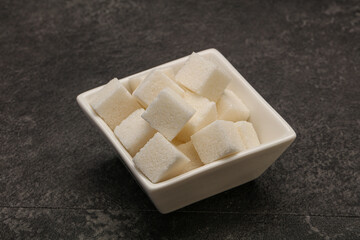 Refined white sugar cubs in the bowl