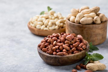 Raw dried fresh peanut nuts on a stone background