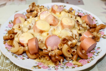 Hot macaroni with sausage and melted cheese.