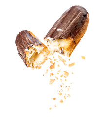 Delicious chocolate eclair broken into two halves in the air close-up, isolated on a white...