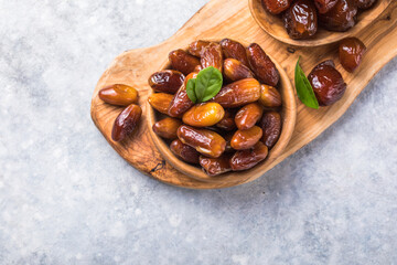 Dates or dattes palm fruit in wooden bowl is snack healthy.