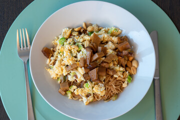 Asian noddles with omelette, peanuts, spicy red pepper and ketyap and vegetarian meat called seitan