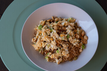 Asian noddles with omelette, peanuts, spicy red pepper and ketyap and vegetarian meat called seitan