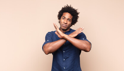 young black afro man looking impatient and angry, pointing at watch, asking for punctuality, wants...