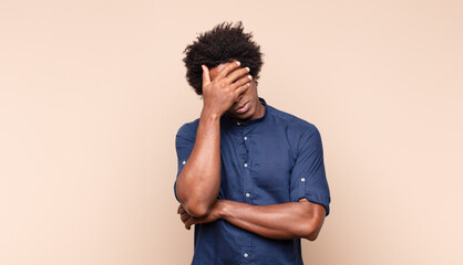 young black afro man looking arrogant, successful, positive and proud, pointing to self