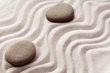 Fototapeta na wymiar zen meditation stone background with stones and lines in sand for relaxation balance and harmony spirituality or spa wellness
