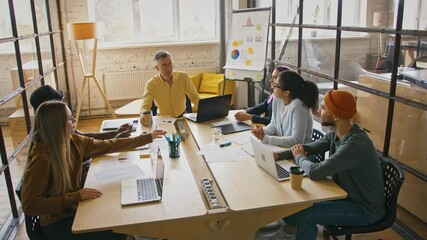 Brainstorming meeting. Creative team discussing new ideas in coworking space - Powered by Adobe