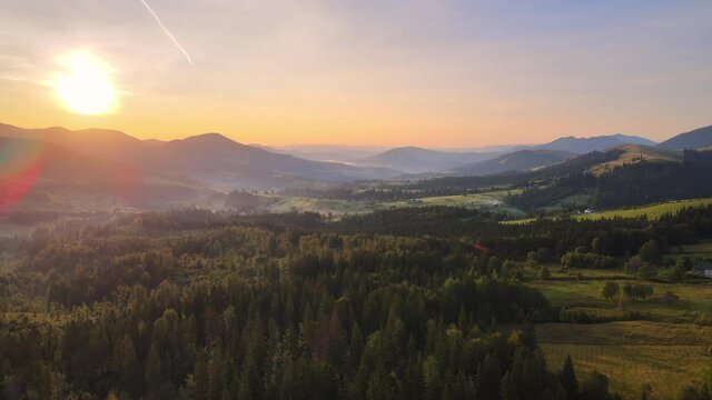 4K Aerial drone summer view of mountain valley at sunrise, amazing nature and mountain range on the background
