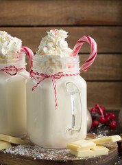 Christmas winter hot white chocolate drink with whipped cream and candy cane