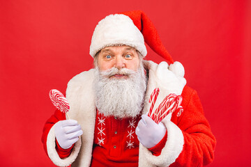 Santa Claus standing isolated on red background. Christmas and new year concept.