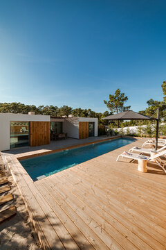 Modern house with garden swimming pool and wooden deck