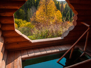 Holy spring and wooden house with plunge font pool for ablutions, relaxing in a natural park.