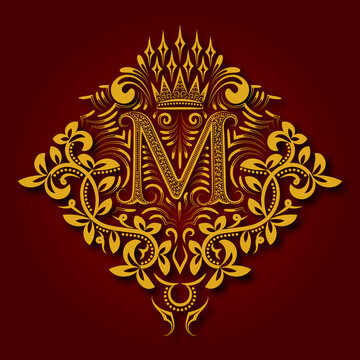 Letter M heraldic monogram in coats of arms form. Vintage golden logo with shadow on maroon background. Letter M is surrounded by floral elements of design.