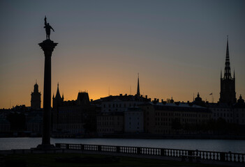 Orange silhouette skyline over the old town Gamla Stan in Stockholm at sunrise