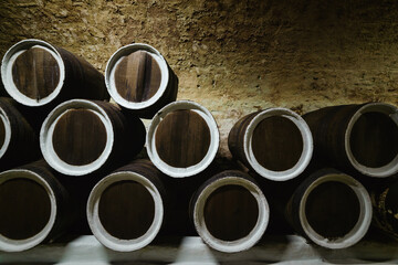 Old wine oak barrels in the cellar at the winery