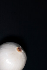 One head of white peeled onion in the lower-left corner of the screen. The upper part of the image is free.