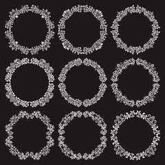 Floral patterned round frames set for design in victorian vintage style. White circular wreaths on black background.