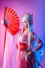 a woman in a geisha costume with a katana and a fan