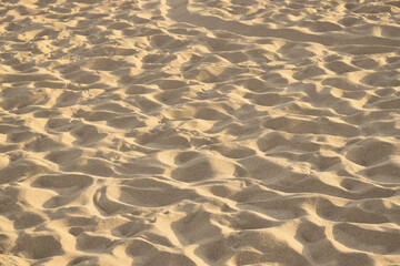 Detail of the sand of a beach with shapes, reliefs and random grooves