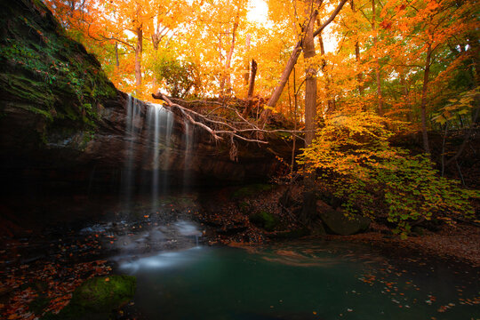Crawn Hill waterfall in twinburg Ohio.Autumn season colorful of leafs.Good vibe with nature. Long explorer shutter and selective focus.