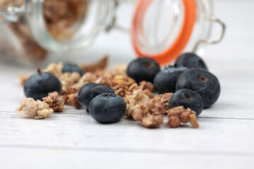 blueberry and glass can of granola close up. Healthy eating concept.