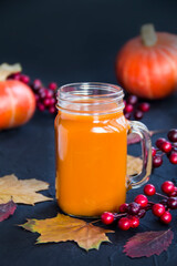 Halloween cocktail, pumpkin orange drink with spices. Dark vintage dirty background. Creative atmospheric decoration