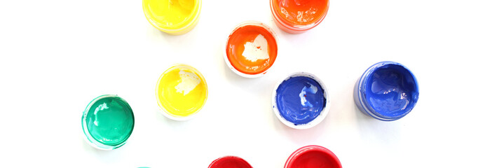 Open gouache jars on white background,top view.Copy space.advertising of master classes for painting and drawing lessons