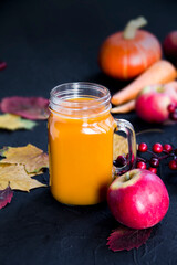 Halloween cocktail, pumpkin orange drink with spices. Dark vintage dirty background. Creative atmospheric decoration