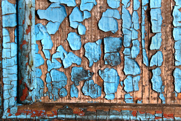 Texture of old wooden wall with peeled blue paint abstract background.