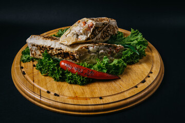 chicken doner kebab wrap on wooden board. High quality photo