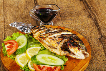 Grilled dorada fish with sauce