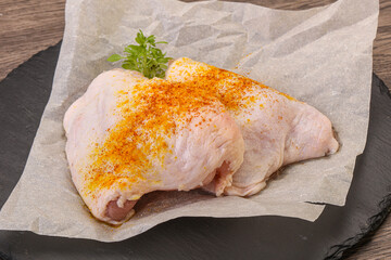 Raw chicken thigh with spices