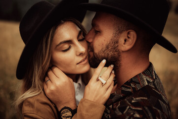 Stylish young and beautiful couple  photographed outdoors in the mountains at their elopement. © Doralin