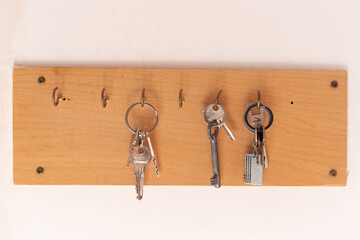 Wooden key holder on bright wall, close up