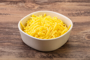 Shredded yellow cheese in the bowl