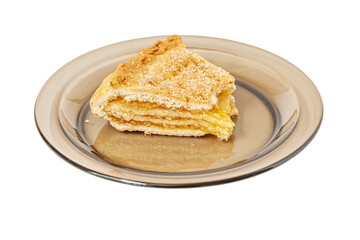 bitten homemade lemon pie on glass plate isolated on white