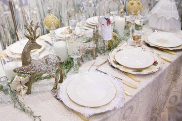 White crockery and lace tablecloth. New Year's table.