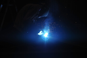 Welder assembling technical steel. Industrial welding of metal structures