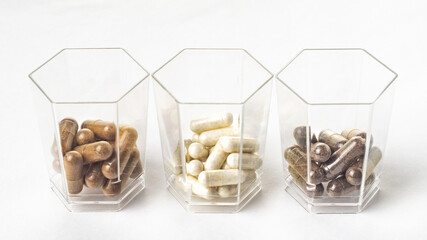 Medical capsules and tablets in hexagonal transparent jars similar to the cell