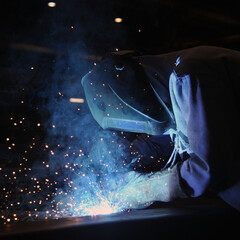 Welder assembling technical steel. Industrial welding of metal structures