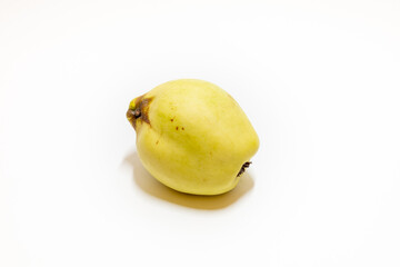 Fresh green quince isolated on white background
