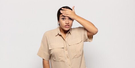 pretty young woman panicking over a forgotten deadline, feeling stressed, having to cover up a mess...