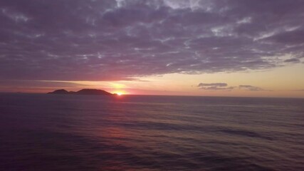 Sunrise in the Sea, low level drone flight in the Atlantic Ocean, Campeche Island, Florianópolis, Brazil