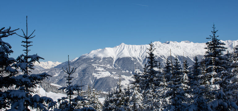 
View in winter of snowy mountain range in Serfaus-Fiss-Ladis, Tyrol, Austria with blue sky