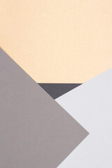 Creative abstract geometric paper background light gray, black colors and brown craft paper. Top view. Copy space