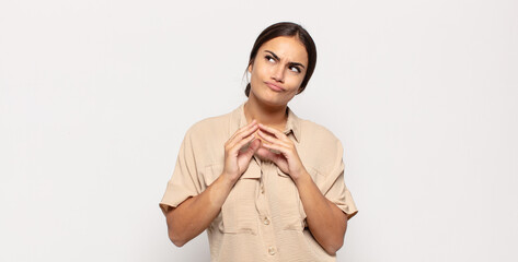 pretty young woman scheming and conspiring, thinking devious tricks and cheats, cunning and...