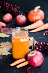 Halloween cocktail, pumpkin orange drink with spices. Dark vintage dirty background. Creative atmospheric decoration